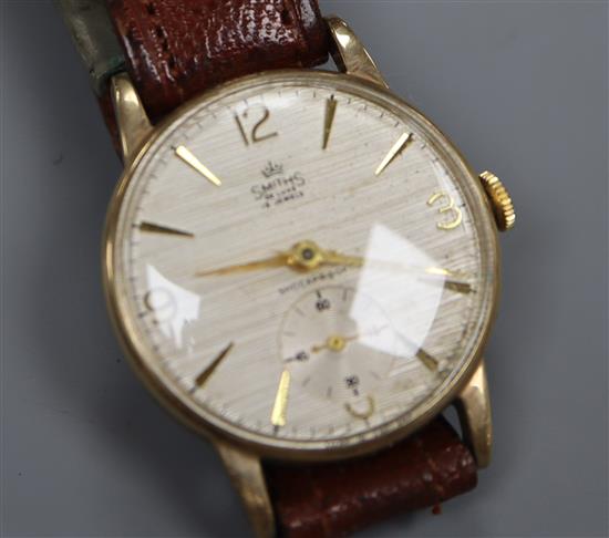 A gentlemans Smiths 9ct gold wristwatch with textured satin Arabic dial and subsidiary seconds.